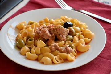 Conchiglie pasta prepared with tuna and olives