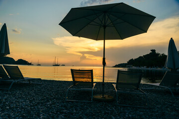view of sea beach with sun loungers and umbrellas