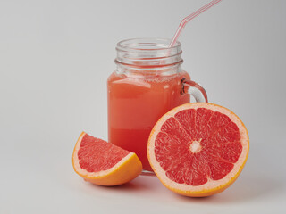 Glass of grapefruit juice isolated on white