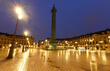 The Vendome column , the Place Vendome at rainy night, Paris, France.