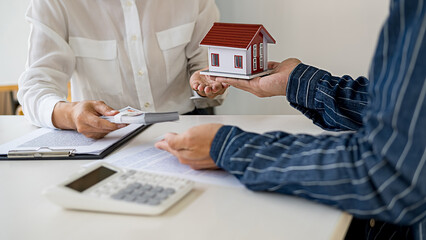 Real estate agent and customer signing contract to buy house, insurance or loan real estate.