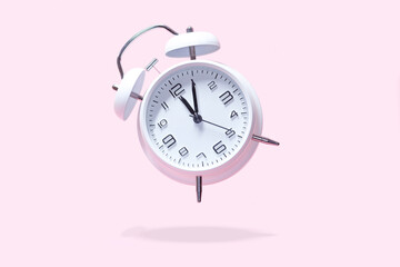 White bell alarm clock hovering over pastel pink background. 5 after 12 clock, countdown too late...
