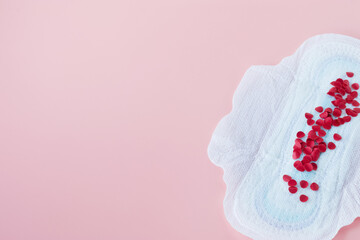 Empty space for the text. Women's hygiene. Sanitary napkin on a pink background.