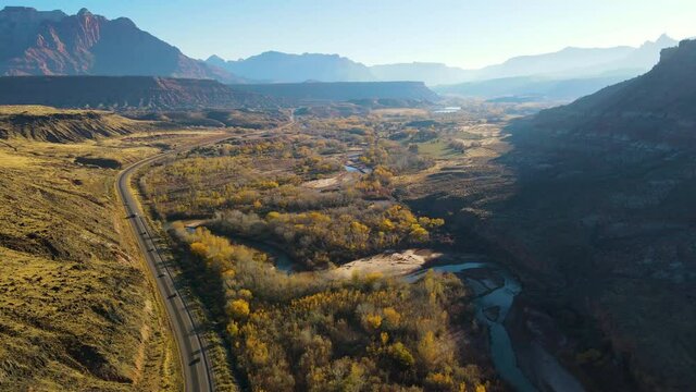 Cinematic aerial shot of winding river near Zion Canyon in Utah