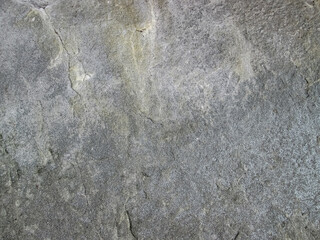 Grainy gray texture with dents. Irregularities on solid stone.