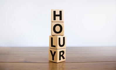 Holy hour symbol. Turned wooden cubes with words holy hour. Beautiful wooden table, white...