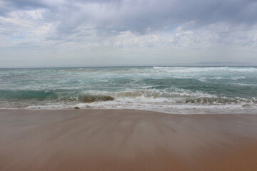 Fototapeta na wymiar Sandy beach with beautiful water waves