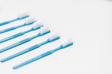 Plastic blue toothbrushes with toothpaste isolated on a white background. High quality photo