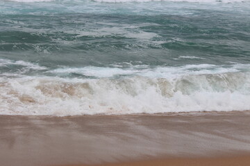 Sandy beach with beautiful water waves