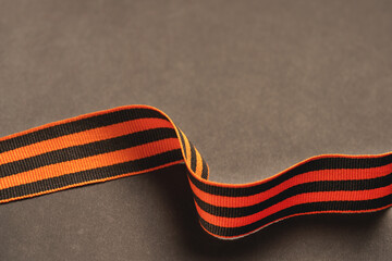 Background for Greeting Card of May 9 victory day. Striped ribbon of St. George's on black.