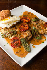 Chicken fried steak. Flank steak battered & deep fried in cast iron skillet. Classic American southern, low country cuisine. Made from scratch chicken fried steak served with gravy and side dishes.