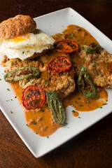 Chicken fried steak. Flank steak battered & deep fried in cast iron skillet. Classic American southern, low country cuisine. Made from scratch chicken fried steak served with gravy and side dishes.