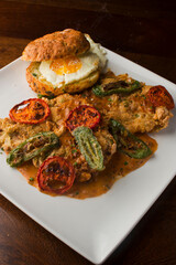 Chicken fried steak. Flank steak battered & deep fried in cast iron skillet. Classic American southern, low country cuisine. Made from scratch chicken fried steak served with gravy and side dishes.
