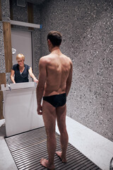 Obraz premium Woman working in recovery spa centre with male visitor