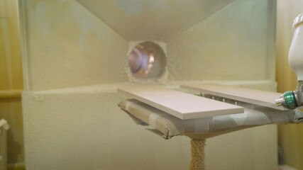 Furniture manufacturing in progress, gluing. Close-up of a tool applying glue to the lining of a...