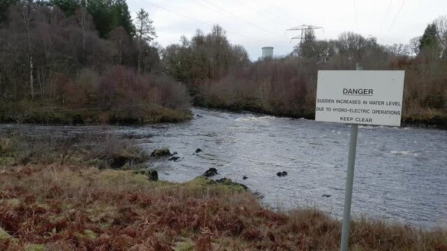 Danger fast flowing water sign beside the Water of Ken at Kendoon Power Station