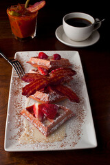 French toast. Classic American restaurant breakfast or brunch favorite. Brioche toast fried in butter and served with strawberries, blackberries, whipped cream powdered sugar and maple syrup.