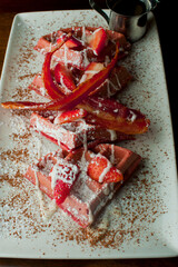 French toast. Classic American restaurant breakfast or brunch favorite. Brioche toast fried in butter and served with strawberries, blackberries, whipped cream powdered sugar and maple syrup.