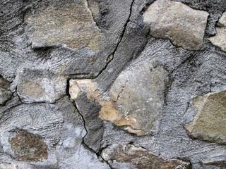 Surface with concrete and broken brick. Cracked floor on the road. Destruction effect.