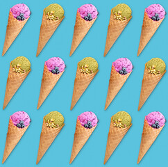 Symmetrical arrangement of ice cream cones on turquoise background, colorful sweet food pattern