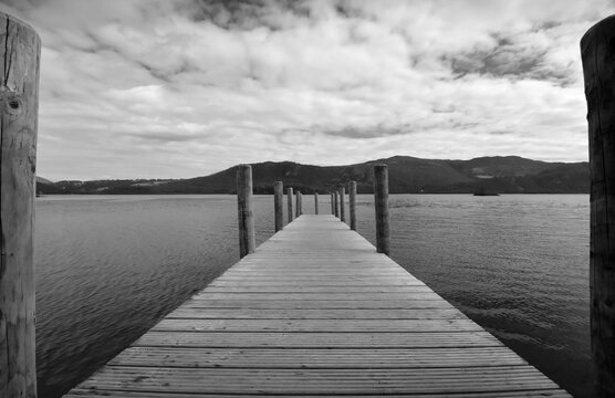 Wooden Pier Over Lake Against Sky