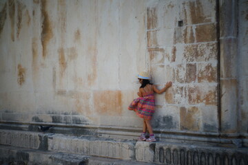 Fototapeta na wymiar Girl balancing on an edge in the old town of Trogir