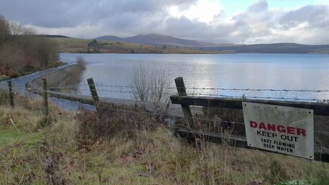 Danger fast water sign at Clatteringshaws Loch and Dam, Galloway, Scotland