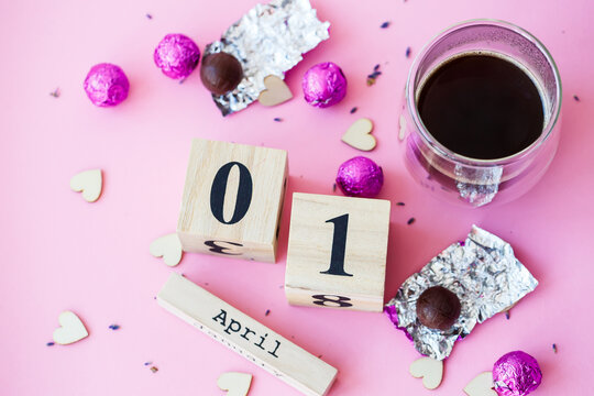 Hi spring. Wooden calendar with date 1 April, on pink background. World laughing day