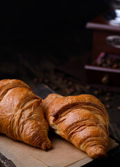 croissants on a wooden board on a brown background