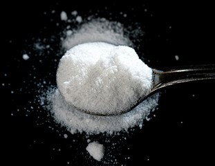 selective focus photo of citrulline malate in an iron spoon. dietary concept. dietary supplement...