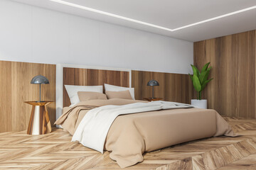 Wooden bedroom, bed with linens on parquet floor and lamps