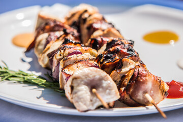 Grilled skewer on white plate. The food in the restaurant. Food styling and restaurant meal serving.