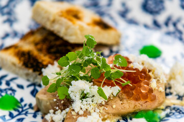 Chicken breast with caviar balls and herbs. The food in the restaurant. Food styling and restaurant meal serving.