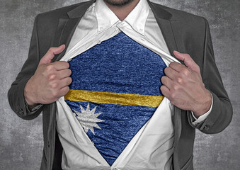 Business man show t-shirt flag of Nauru rips open his shirt