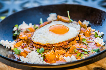 Chicken sote with pancakes and egg. The food in the restaurant. Food styling and restaurant meal serving.