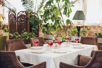 table setting in the restaurant Glasses with wine