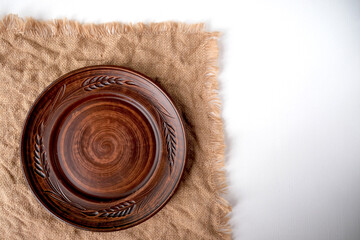 Table setting in Russian style and a ceramic plate on a brown table. Top view with copy space. High quality photo