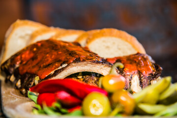 Grilled ribs with bread and side dish. The food in the restaurant. Food styling and restaurant meal serving.