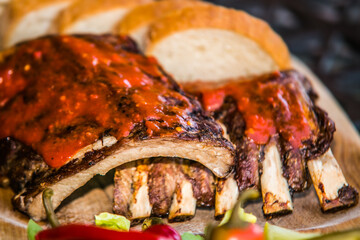 Grilled ribs with bread and side dish. The food in the restaurant. Food styling and restaurant meal serving.