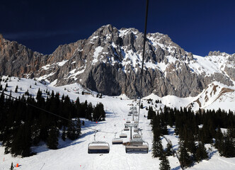 Ski Area Ehrwalder Alm With View To Mount Zugpitze Austria During A Chairlift Ride On A Beautiful...