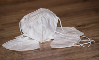 White respiratory mask N95 FFP2 on a wooden background close-up. Coronavirus Medical Protection Concept. Protective masks. Protection against pollution, virus, flu and corona virus.