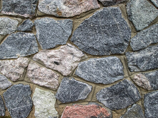 Beautiful masonry of stones of different sizes. Stock background with a neutral natural background.