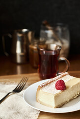 Slice of tasty  cheesecake on white plate, New York style classical cheese cake, close up