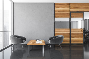 Office waiting area. There are two armchairs near a coffee table, a empty wall and a room with...