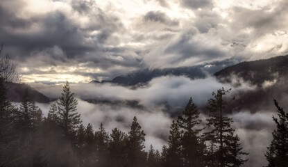 Dramatic Scenic Nature Panoramic View of Canadian Mountain Landscape covered in clouds. Artistic Render. Located near Squamish and Whistler, British Columbia, Canada.