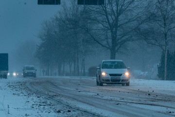 Cars driving in the snowstorm, cars driving in the snow, cars on a snow-covered street, Berlin, Germany