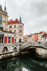 Fototapeta na wymiar View of river Ljubljanica and Tromostovje. Center of capital of Slovenia Ljubljana. Europe.