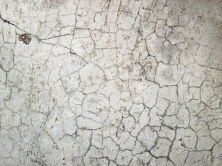 Mosaic of cracks and scratches. A very old battered stone in a light shade.