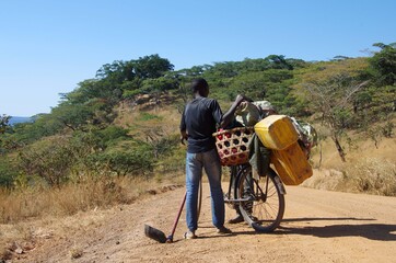 Cyclist on a dirt road between Kigoma and Mpanda in Tanzania