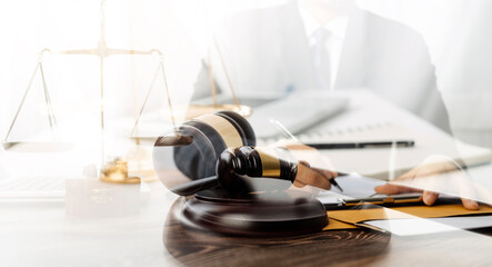 Business and lawyers discussing contract papers with brass scale on desk in office. Law, legal services, advice, justice and law concept picture with film grain effect